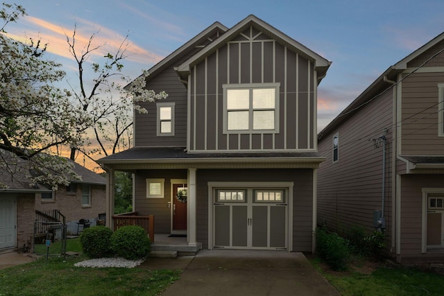 view of front facade with a porch, board and batten siding, a garage, and concrete driveway