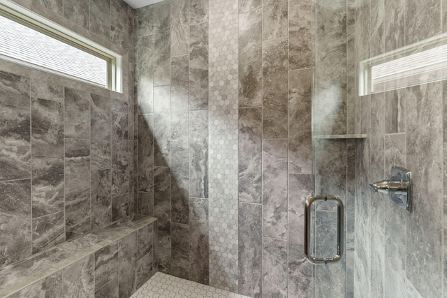 bathroom featuring a stall shower and plenty of natural light