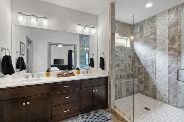 full bathroom featuring double vanity, ensuite bath, a sink, and a stall shower