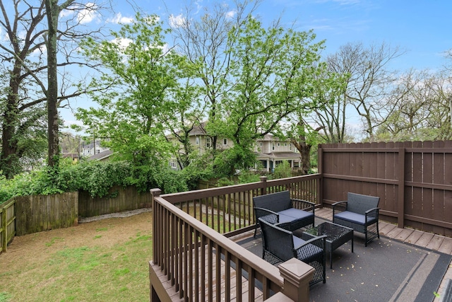 wooden deck featuring outdoor lounge area, a fenced backyard, and a lawn