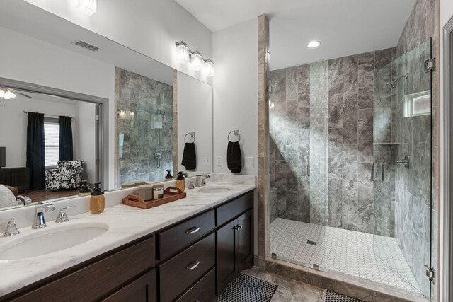 full bathroom featuring a sink, visible vents, double vanity, and a stall shower