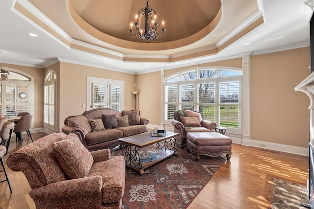 763 Plantation Way, Gallatin, TN 37066 - living room featuring a raised ceiling, an inviting chandelier, and wood finished floors