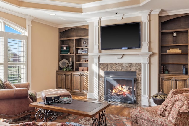 763 Plantation Way, Gallatin, TN 37066 - living area with built in features, ornamental molding, a fireplace, a tray ceiling, and wood finished floors