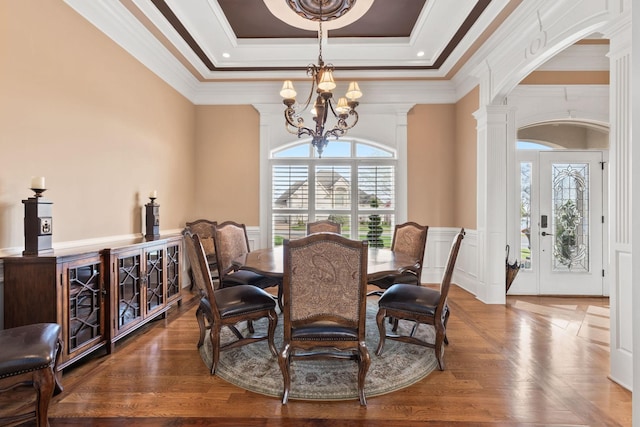 763 Plantation Way, Gallatin, TN 37066 - dining space with an inviting chandelier, ornate columns, wood finished floors, wainscoting, and a raised ceiling
