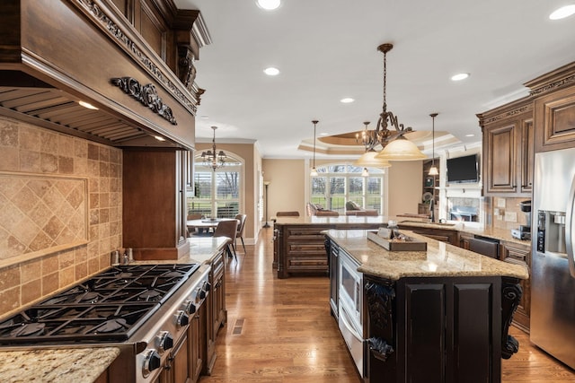 763 Plantation Way, Gallatin, TN 37066 - kitchen with light wood-type flooring, an inviting chandelier, premium range hood, crown molding, and stainless steel appliances