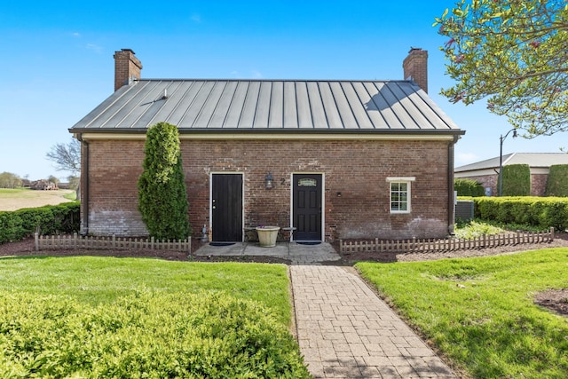 763 Plantation Way, Gallatin, TN 37066 - view of front of home with a standing seam roof, metal roof, a chimney, and brick siding