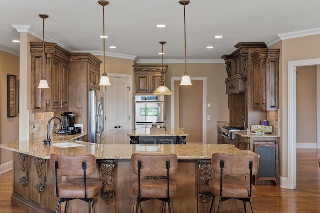 763 Plantation Way, Gallatin, TN 37066 - kitchen featuring light stone counters, a peninsula, dark wood finished floors, stainless steel appliances, and a sink