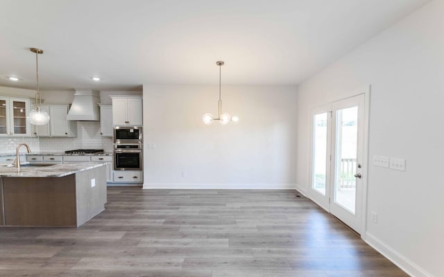 7705 Pine St, Fairview, TN 37062 - kitchen with a sink, stainless steel microwave, custom exhaust hood, gas stovetop, and a chandelier
