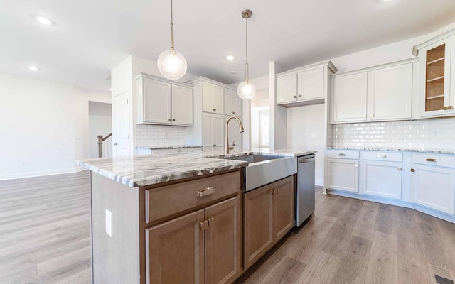 7705 Pine St, Fairview, TN 37062 - kitchen featuring a sink, light wood finished floors, backsplash, light stone counters, and recessed lighting