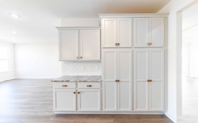7705 Pine St, Fairview, TN 37062 - kitchen featuring light wood-style floors, baseboards, light stone countertops, recessed lighting, and decorative backsplash