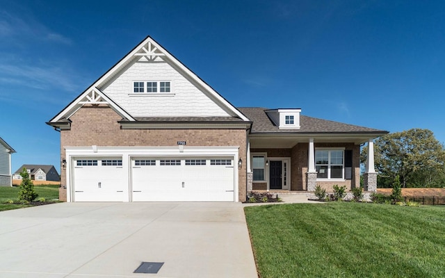 7705 Pine St, Fairview, TN 37062 - craftsman inspired home featuring a front lawn, concrete driveway, brick siding, an attached garage, and a shingled roof