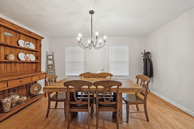 1006 Harmony Ln, Hendersonville, TN 37075 - dining area featuring a chandelier, light wood-type flooring, baseboards, and a textured ceiling