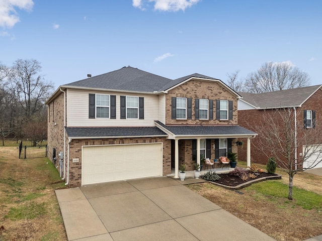 1006 Harmony Ln, Hendersonville, TN 37075 - traditional-style house featuring concrete driveway, an attached garage, brick siding, fence, and covered porch