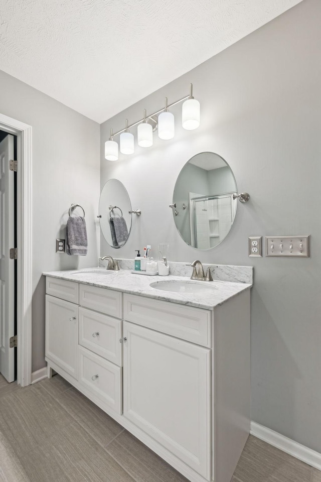 1006 Harmony Ln, Hendersonville, TN 37075 - full bathroom with a sink, baseboards, double vanity, and a shower with door