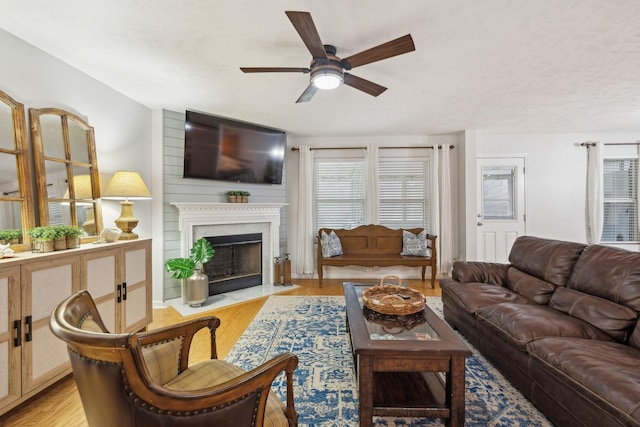 1006 Harmony Ln, Hendersonville, TN 37075 - living room featuring a fireplace with flush hearth, light wood-style floors, and a ceiling fan