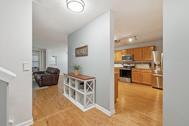 1006 Harmony Ln, Hendersonville, TN 37075 - corridor with baseboards, light wood-style floors, and a textured ceiling