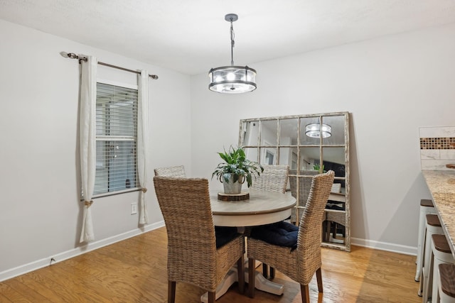 1006 Harmony Ln, Hendersonville, TN 37075 - dining area with light wood finished floors, baseboards, and an inviting chandelier