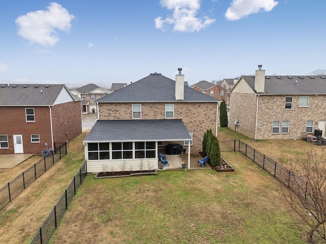 1006 Harmony Ln, Hendersonville, TN 37075 - rear view of property featuring a sunroom, a patio area, a lawn, a fenced backyard, and roof with shingles