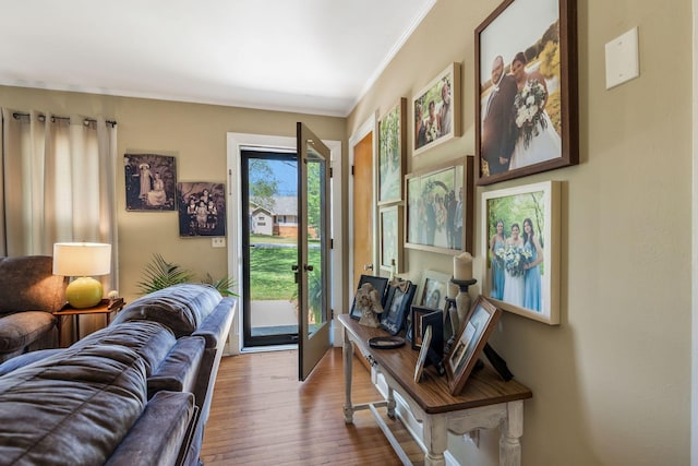 doorway featuring crown molding and wood finished floors
