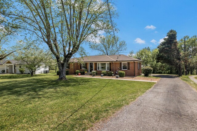 ranch-style house with brick siding, a front lawn, and aphalt driveway