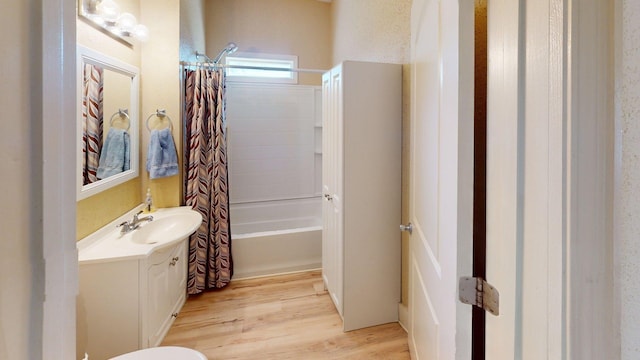 full bathroom featuring shower / bath combination with curtain, vanity, and wood finished floors