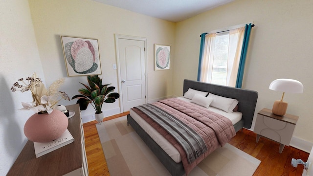 bedroom featuring baseboards and light wood-style flooring