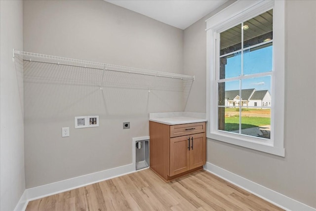 laundry area featuring hookup for an electric dryer, light wood-type flooring, baseboards, washer hookup, and laundry area