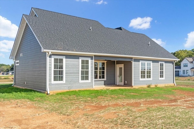 back of property with roof with shingles
