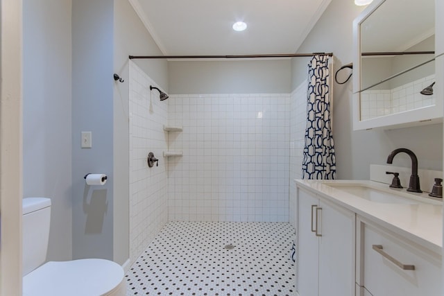 full bath featuring toilet, crown molding, tiled shower, and vanity