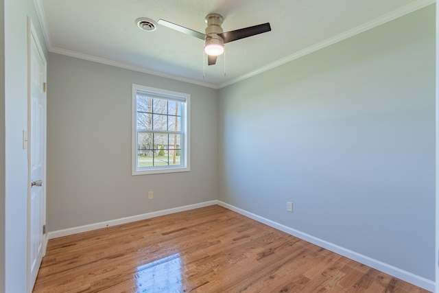 spare room with visible vents, baseboards, ceiling fan, crown molding, and light wood-style flooring