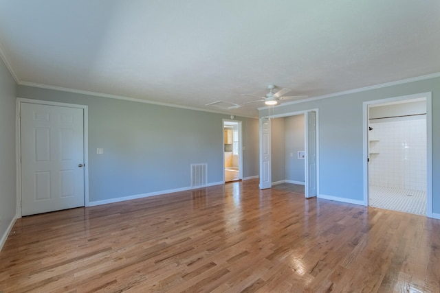 spare room featuring baseboards, visible vents, light wood-type flooring, and a ceiling fan