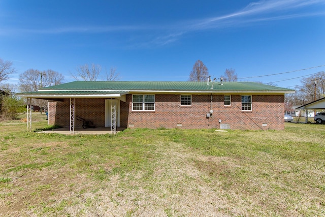 rear view of property featuring brick siding, metal roof, and crawl space