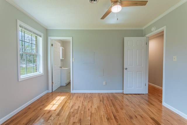 unfurnished bedroom with light wood-style floors, ornamental molding, baseboards, and multiple windows