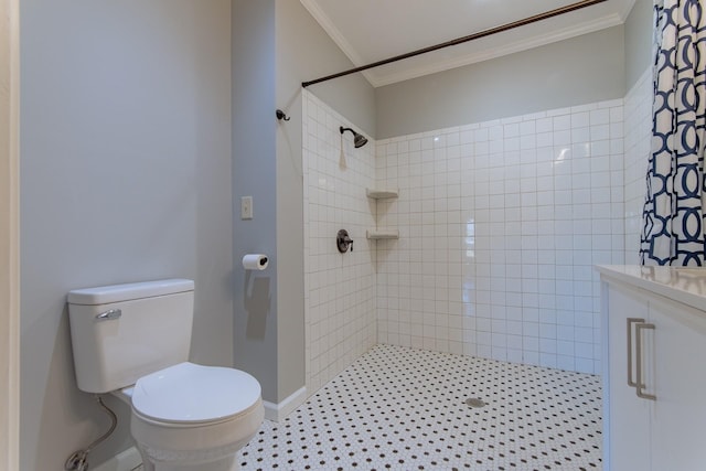 full bath with tiled shower, vanity, ornamental molding, toilet, and baseboards