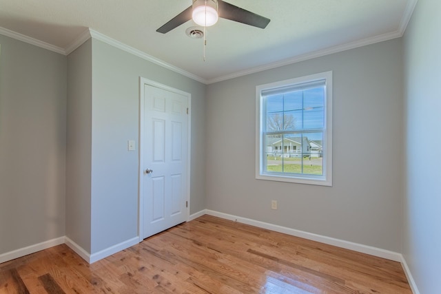 unfurnished bedroom featuring light wood-style flooring, crown molding, baseboards, and visible vents