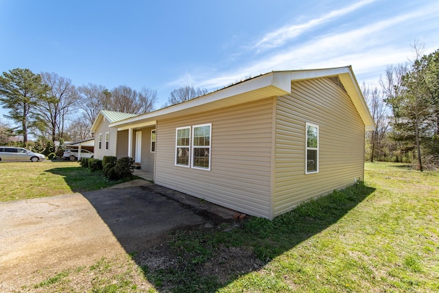 view of property exterior with a lawn