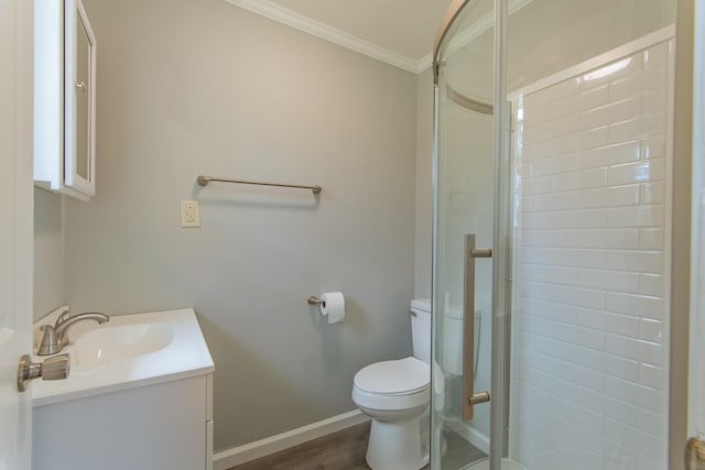 full bath with toilet, vanity, a stall shower, and baseboards