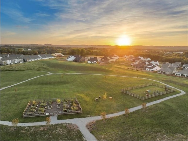 aerial view at dusk featuring a residential view