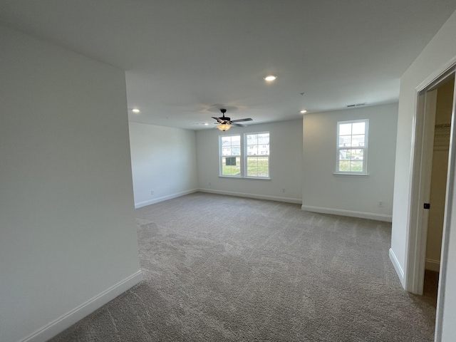 empty room featuring visible vents, baseboards, a ceiling fan, carpet, and recessed lighting