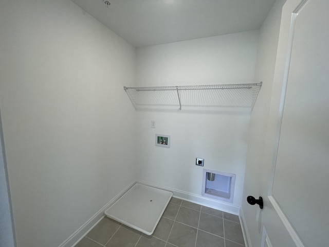 washroom featuring laundry area, electric dryer hookup, dark tile patterned flooring, washer hookup, and baseboards