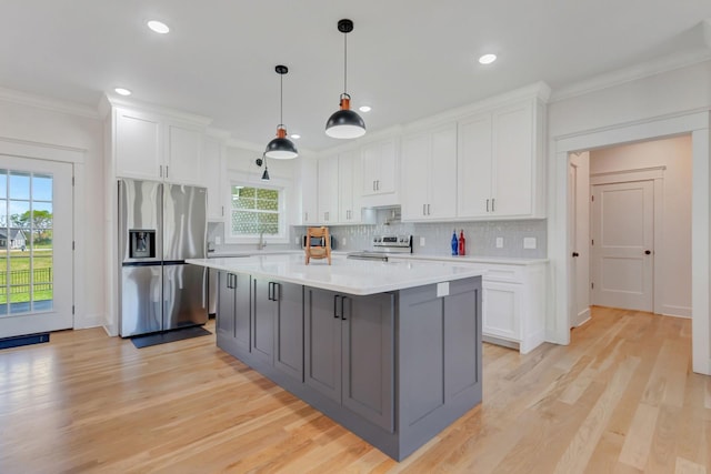 57 Watson Ct, Leoma, TN 38468 - kitchen with appliances with stainless steel finishes, ornamental molding, white cabinets, light countertops, and decorative backsplash