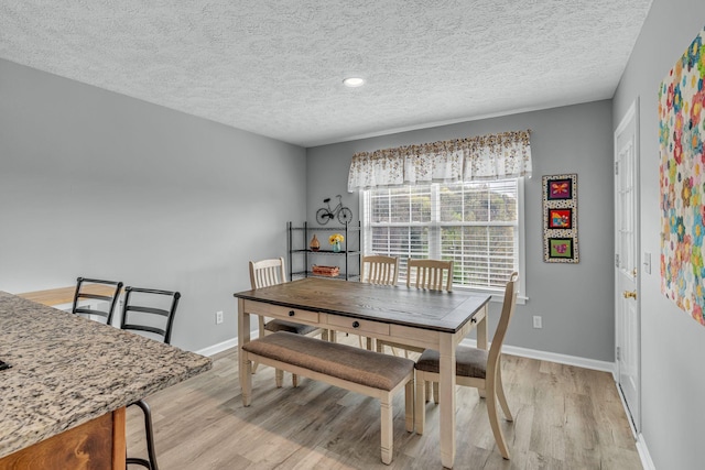 211 Northview Ct, Hendersonville, TN 37075 - dining room featuring a textured ceiling, light wood-style flooring, and baseboards