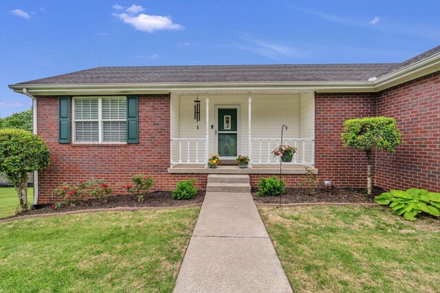 211 Northview Ct, Hendersonville, TN 37075 - view of front of home with a front lawn, brick siding, and a porch
