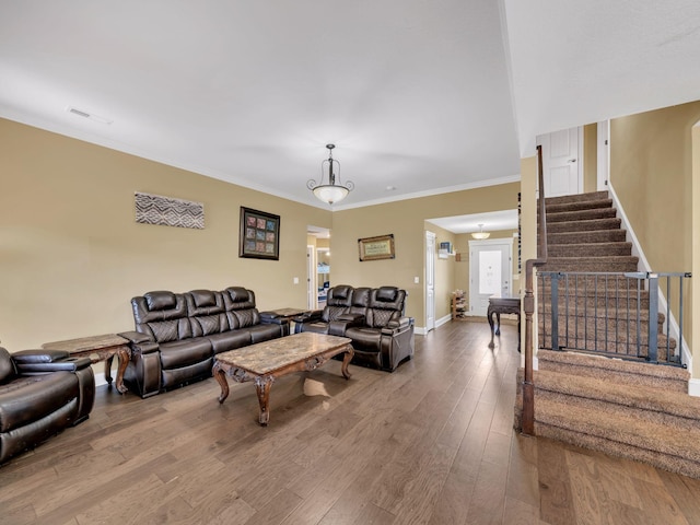 1084 Harrison Way, Clarksville, TN 37042 - living room featuring visible vents, baseboards, wood finished floors, stairway, and ornamental molding