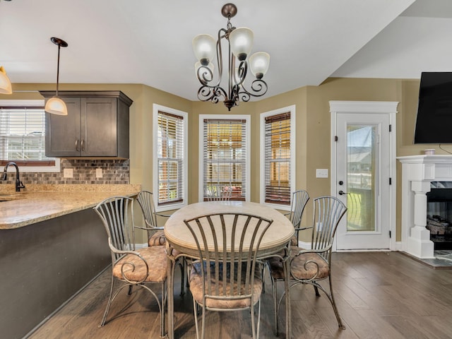 1084 Harrison Way, Clarksville, TN 37042 - dining area with a high end fireplace, baseboards, a chandelier, and dark wood-type flooring
