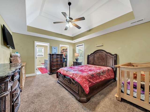 1084 Harrison Way, Clarksville, TN 37042 - bedroom with a spacious closet, carpet floors, a tray ceiling, ensuite bath, and visible vents