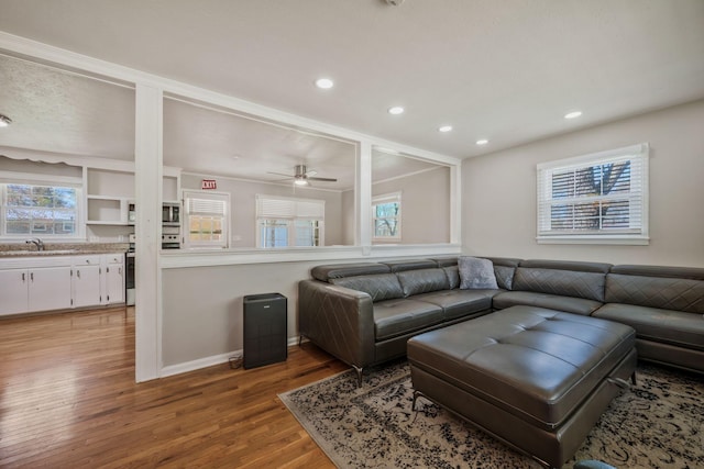 living area featuring recessed lighting, light wood-style flooring, baseboards, and a ceiling fan