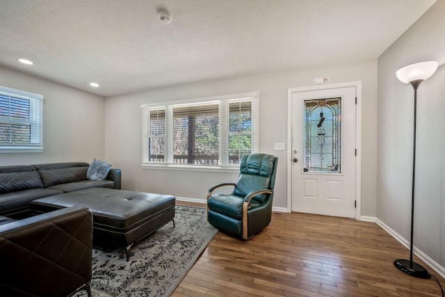 living area with baseboards, recessed lighting, and hardwood / wood-style floors