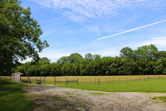 view of yard with a rural view and fence