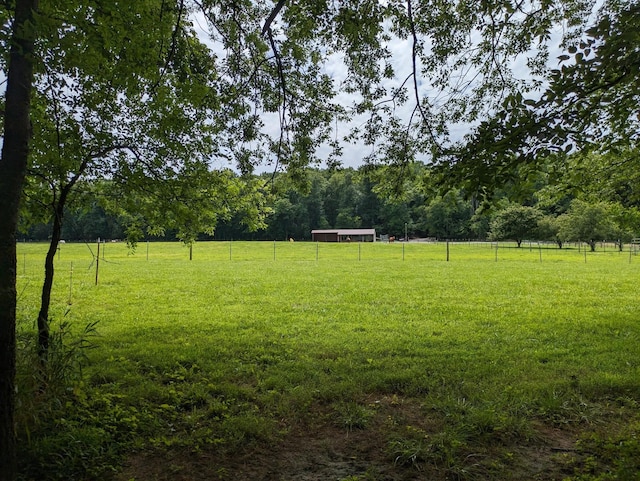 view of yard with a rural view and fence